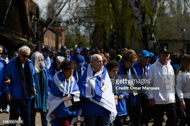Holocaust survivors at the front of the 35th March of the Living with other participants carrying Israel's national flags by the main gate of the...