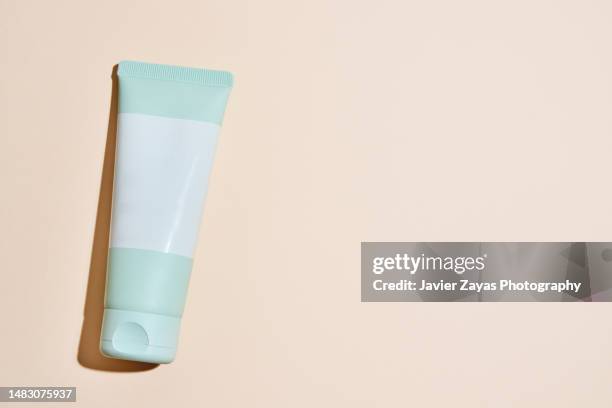 generic green cream tube on pastel background - aftershave bottle stock pictures, royalty-free photos & images