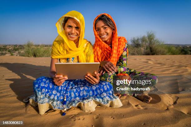 happy indian children using a digital tablet, desert village, india - laptop desert stock pictures, royalty-free photos & images