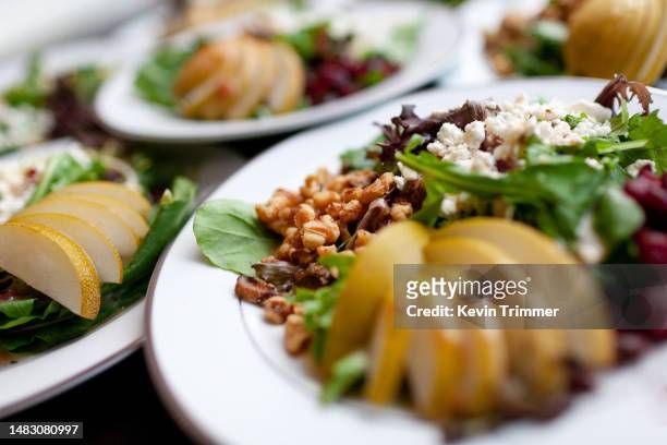 fruits, nuts and cheese on spring greens - plate of food stock pictures, royalty-free photos & images