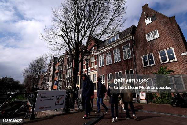 General view of the city centre including the Red Light District, also called "De wallen" by locals a street sign with 'Wildplassen is verboden' or...