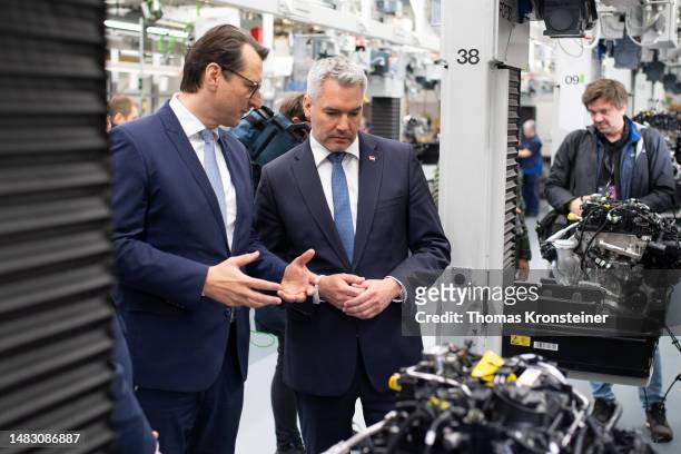 Milan Nedeljković, Member of the Board of Management of BMW AG, and Austrian Chancellor Karl Nehammer inspect the engine assembly line while visiting...