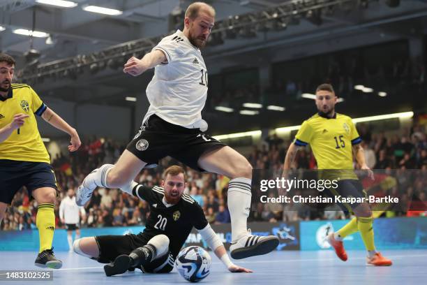 Michael Meyer of Germany challenges Viktor Saeaef of Sweden during the FIFA Futsal World Championship Playoff Second Leg match between Germany and...