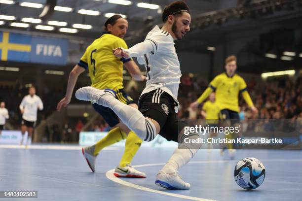 Suad Ak of Germany challenges Liridon Makolli of Sweden during the FIFA Futsal World Championship Playoff Second Leg match between Germany and Sweden...