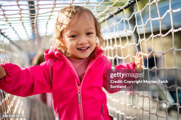 a child having a good time at a playground in jevnaker, norway. - playground equipment stock pictures, royalty-free photos & images