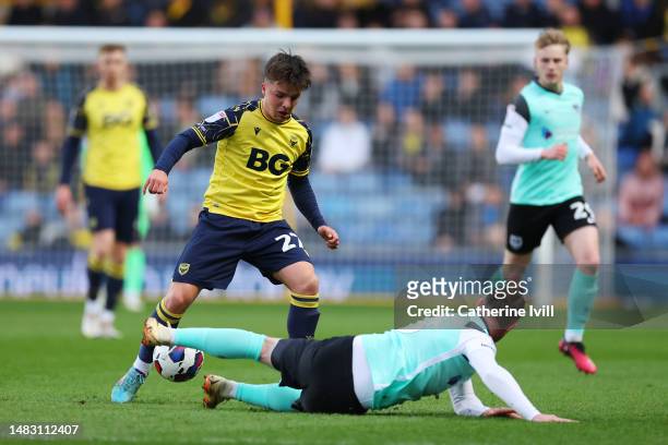 Tyler Goodrham of Oxford United is challenged by Ryan Tunnicliffe of Portsmouth during the Sky Bet League One match between Oxford United and...