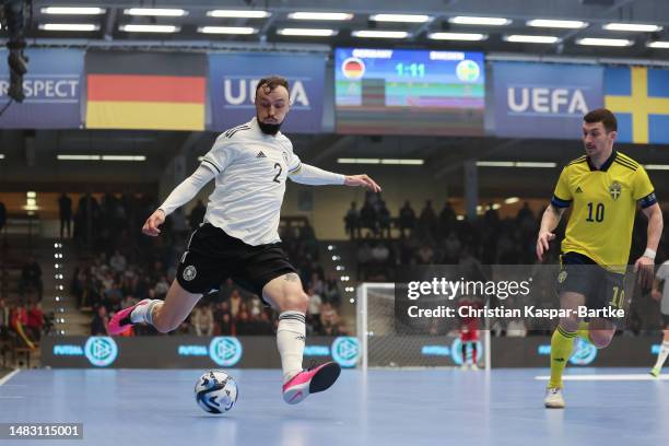 Christopher Wittig of Germany challenges Petrit Zhubi of Sweden during the FIFA Futsal World Championship Playoff Second Leg match between Germany...