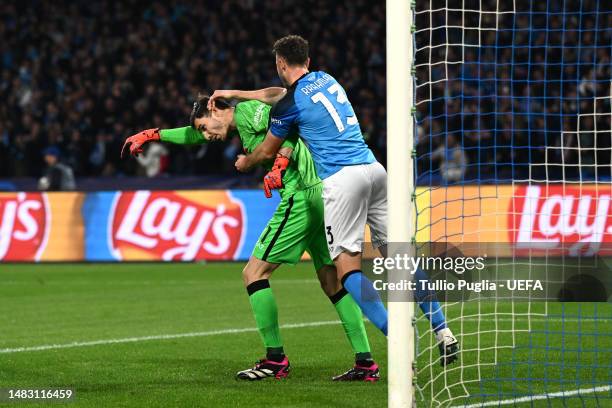 Alex Meret of SSC Napoli is congratulated by teammate Amir Rrahmani after saving the penalty kick by Olivier Giroud of AC Milan during the UEFA...