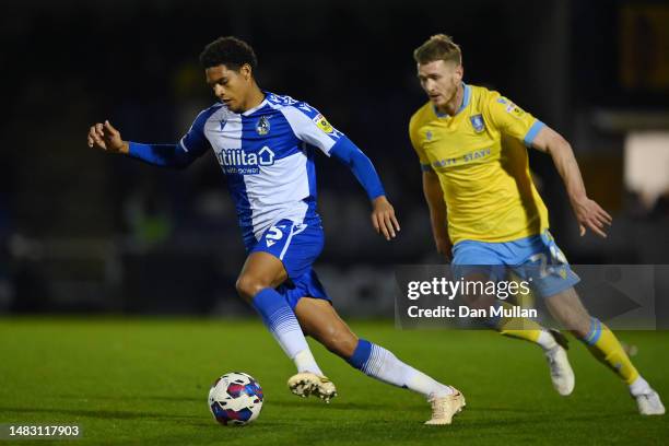 Jarell Quansah of Bristol Rovers runs with the ball whilst under pressure from Michael Smith of Sheffield Wednesday during the Sky Bet League One...