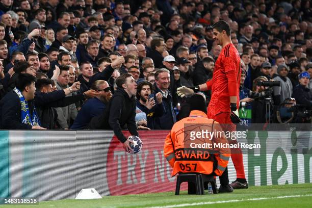 Fan throws the ball away from Thibaut Courtois of Real Madrid during the UEFA Champions League quarterfinal second leg match between Chelsea FC and...