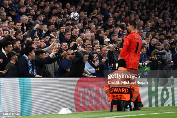 Fan throws the ball away from Thibaut Courtois of Real Madrid during the UEFA Champions League quarterfinal second leg match between Chelsea FC and...