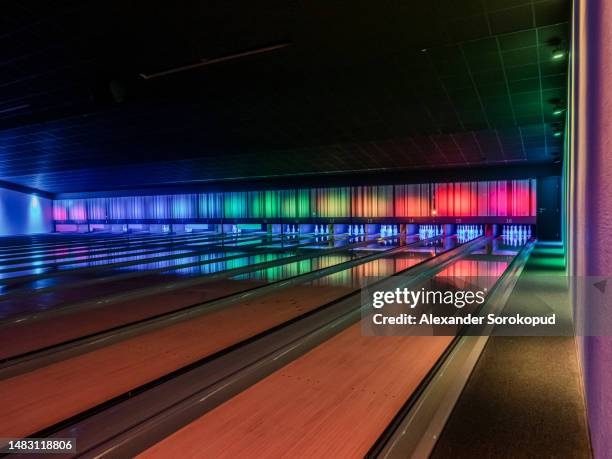multi-colored illumination of lanes in a huge bowling alley. - magenta car stock pictures, royalty-free photos & images