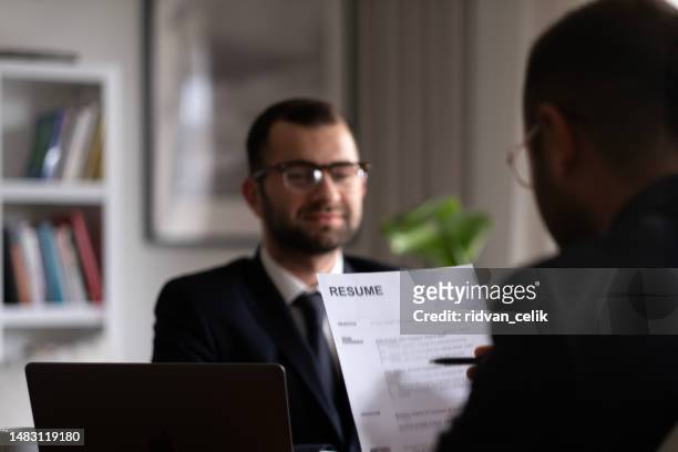 business man review his resume application on desk, laptop computer, job seeker - job vacancy stock pictures, royalty-free photos & images