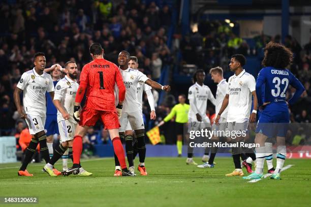 Eder Militao, Daniel Carvajal and David Alaba of Real Madrid celebrate with team mate Thibaut Courtois after saving a shot from Marc Cucurella of...