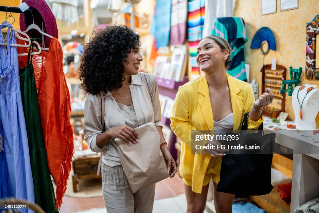 Giovani amiche che acquistano al negozio di abbigliamento