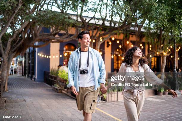 traveler young couple walking along the historic district - honeymoon stock pictures, royalty-free photos & images