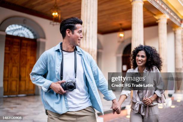 traveler young couple walking along the historic district - walking toward camera stock pictures, royalty-free photos & images