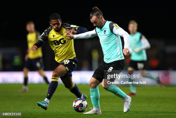 Ryan Tunnicliffe of Portsmouth battles for possession with Marcus McGuane of Oxford United during the Sky Bet League One match between Oxford United...