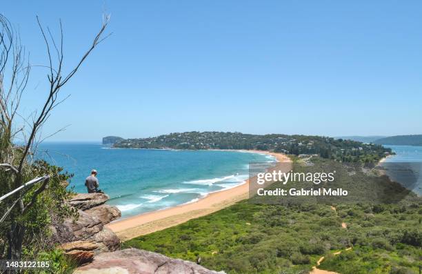 man at the edge of cliff staring the views over palm beach - palm beach nsw stock pictures, royalty-free photos & images