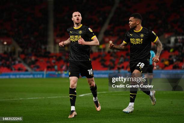 Will Keane of Wigan Athletic celebrates after scoring the team's first goal with teammate Josh Magennis during the Sky Bet Championship match between...