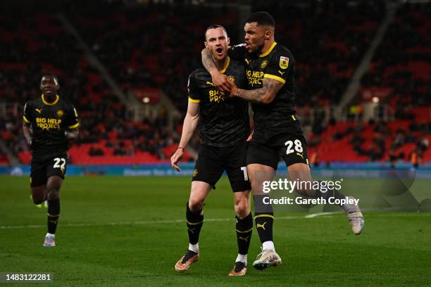 Will Keane of Wigan Athletic celebrates after scoring the team's first goal with teammate Josh Magennis during the Sky Bet Championship match between...