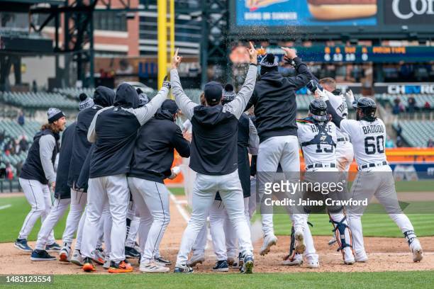 The Detroit Tigers wait for Kerry Carpenter at home plate following his walk off home run in game one of a double header against the Cleveland...