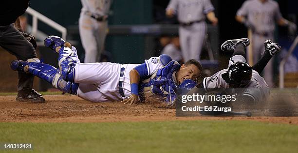 Orlando Hudson of the Chicago White Sox is tagged out at home by Salvador Perez of the Kansas City Royals as he tries to score on a A.J. Pierzynski...