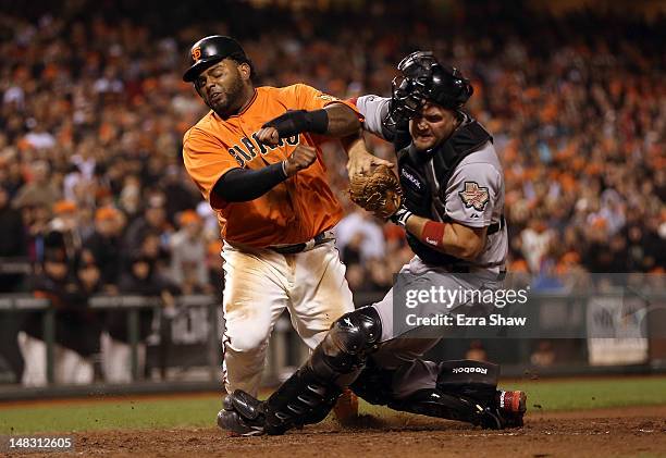 Pablo Sandoval of the San Francisco Giants collides with Chris Snyder of the Houston Astros in the eighth inning at AT&T Park on July 13, 2012 in San...