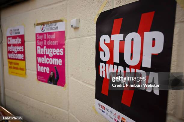 Stop Rwanda' poster is seen at the Stand Up To Racism Dorset public meeting, held to discuss the refugee barge due to moor at the port, on April 18,...