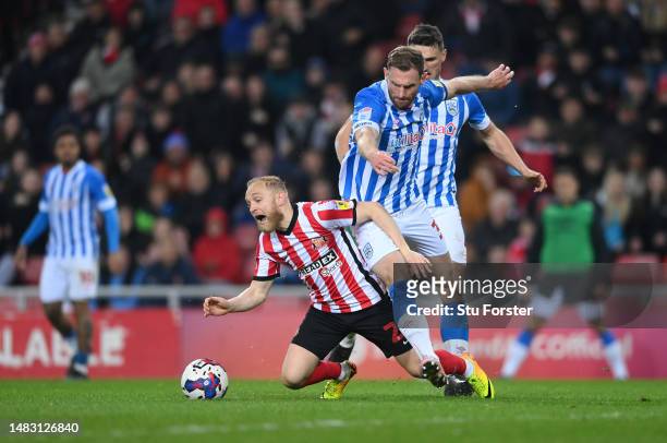 Alex Pritchard of Sunderland is challenged in the penalty box by Tom Lees of Huddersfield during the Sky Bet Championship between Sunderland and...