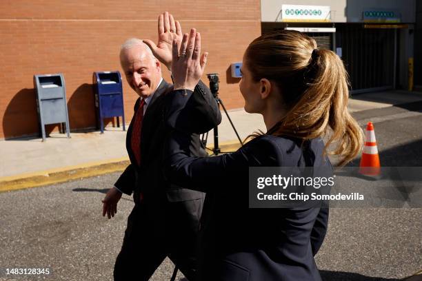Lawyers representing Dominion Voting Systems Rodney Smolla and Valerie Caras high-five as they leave the Leonard Williams Justice Center following a...