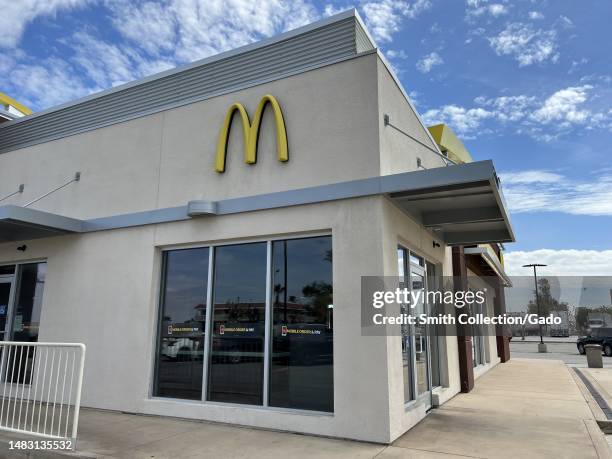 McDonald's facade with Mobile Order & Pay signage under a cloudy sky, Buttonwillow, California, April 7, 2023.