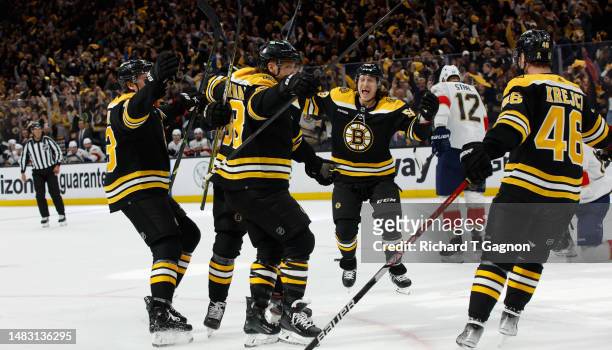 David Pastrnak of the Boston Bruins celebrates his goal against the Florida Panthers with his teammate Pavel Zacha, Tyler Bertuzzi, Charlie McAvoy...
