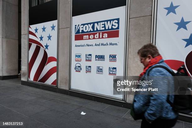 People walk by the News Corporation headquarters, home to Fox News, on April 18, 2023 in New York City. Moments before opening arguments were set to...
