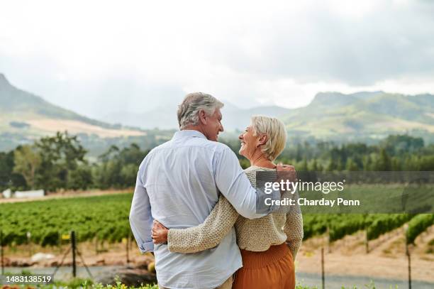 rear view of cheerful senior couple hugging in vineyard - senior couple smiling stock pictures, royalty-free photos & images