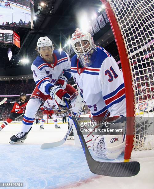 Braden Schneider and Igor Shesterkin of the New York Rangers defend the net against the New Jersey Devils during the first period of Game One in the...