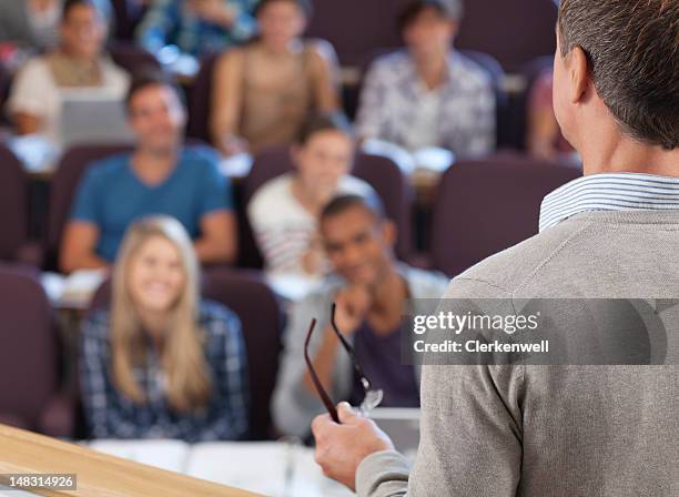 professor and students in lecture hall - professor stockfoto's en -beelden