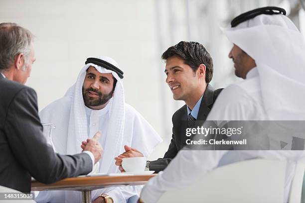 businessmen talking in meeting - arab businessman stock pictures, royalty-free photos & images