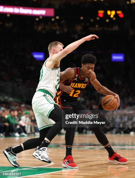 De'Andre Hunter of the Atlanta Hawks dribbles down court against Sam Hauser of the Boston Celtics during the second quarter of Game Two of the...