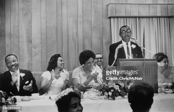 Dr Martin Luther King, Coretta Scott King laugh with politician and jurist Constance Baker Motley at banquet at the SCLC Conference while Reverend...
