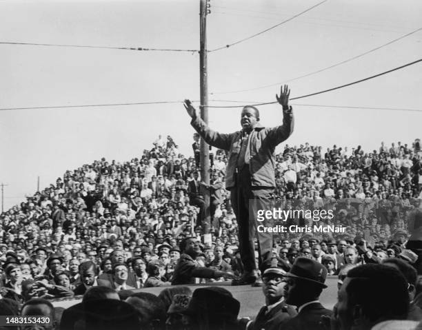 Reverend Ralph Abernathy addresses the crowd of mourners from the roof of an ambulance at Dr. Martin Luther King's funeral on April 9, 1968 in...