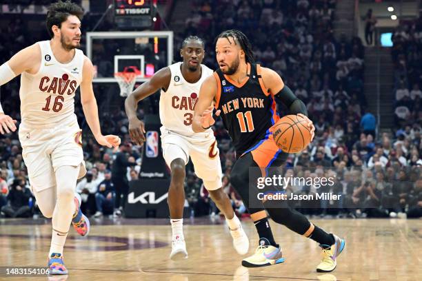 Jalen Brunson of the New York Knicks drives to the basket around Cedi Osman and Caris LeVert of the Cleveland Cavaliers during the first quarter of...