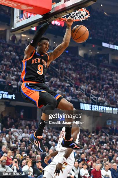 Barrett of the New York Knicks dunks over Caris LeVert of the Cleveland Cavaliers during the first quarter of Game Two of the Eastern Conference...