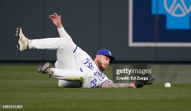 Kyle Isbel of the Kansas City Royals comes up short on a ball off the bat of Ezequiel Duran of the Texas Rangers that was scored an RBI single in the...