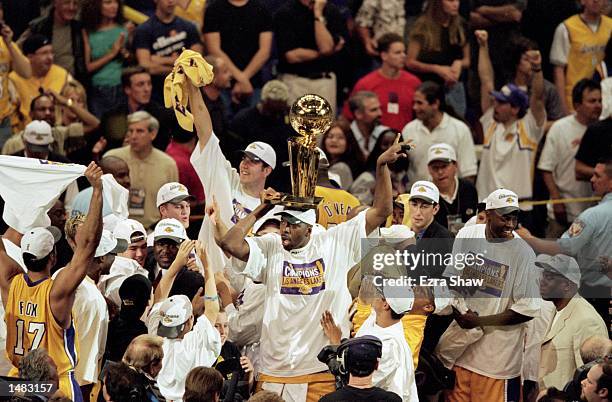 John Salley of the Los Angeles Lakers holds the NBA championship trophy on his head after winning the NBA Finals Game 6 against the Indiana Pacers at...