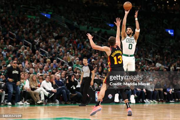 Jayson Tatum of the Boston Celtics takes a shot over Bogdan Bogdanovic of the Atlanta Hawks during the fourth quarter of Game Two of the Eastern...