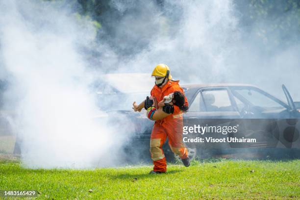 firefighters save a child from a fire in a car accident,firefighter. - victim services stock pictures, royalty-free photos & images