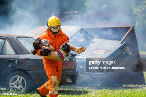 firefighter to save child in fire in a car accident. - victim services stock pictures, royalty-free photos & images