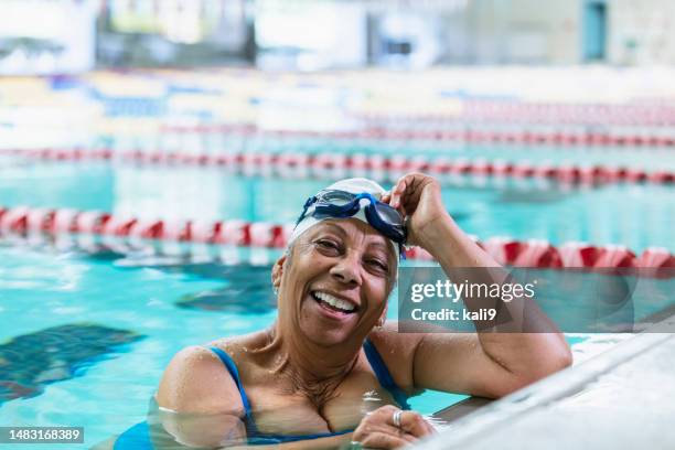 senior african-american woman at pool swimming laps - swimming lane marker stock pictures, royalty-free photos & images