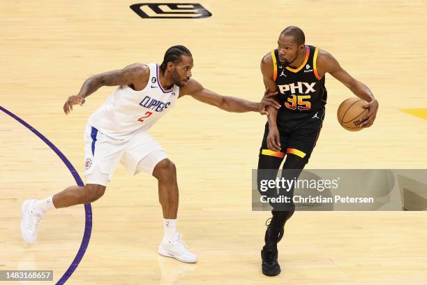 Kevin Durant of the Phoenix Suns handles the ball against Kawhi Leonard of the LA Clippers during the first half of Game Two of the Western...